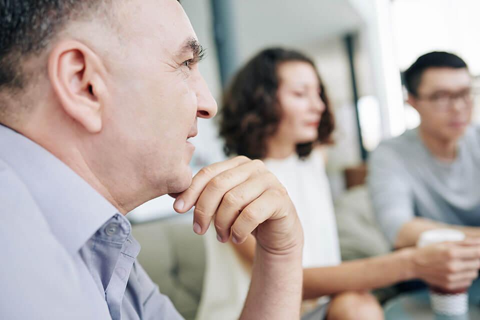 three employees in a meeting